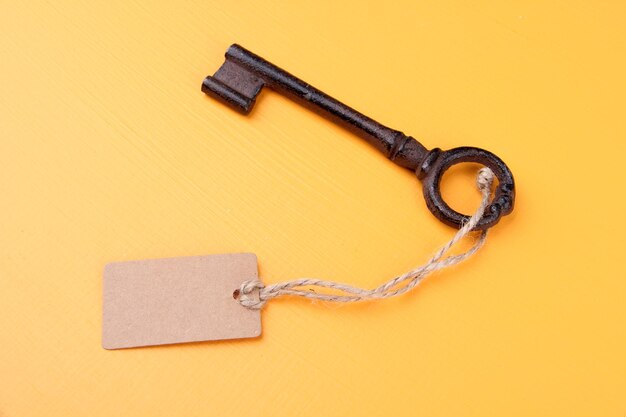 Photo key with empty tag on color background