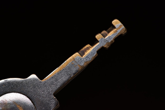 A key with a gold colored metal handle