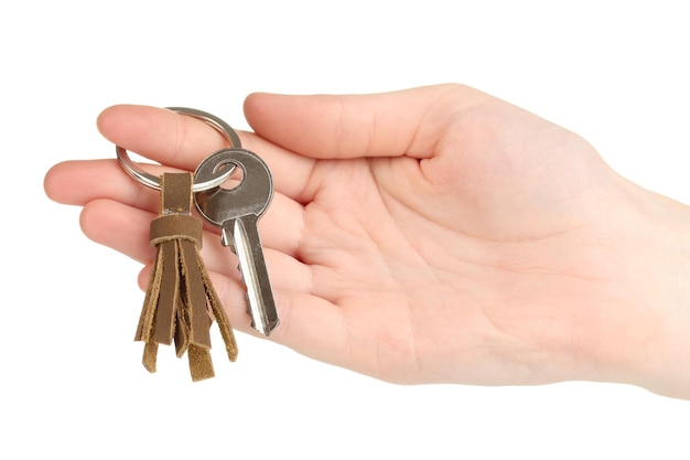 Key with leather trinket in hand isolated on white