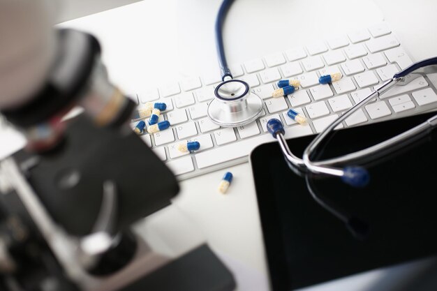 Photo on the keyboard are capsules and a stethoscope