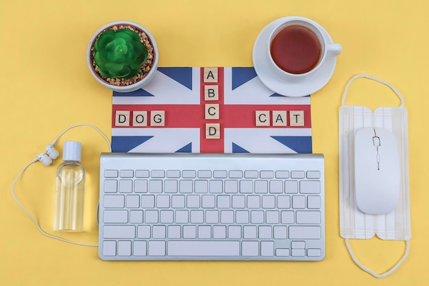 Photo keyboard british flag and mask on yellow