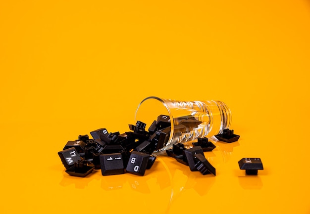 Keyboard button in glass in jar in bucket on orange background