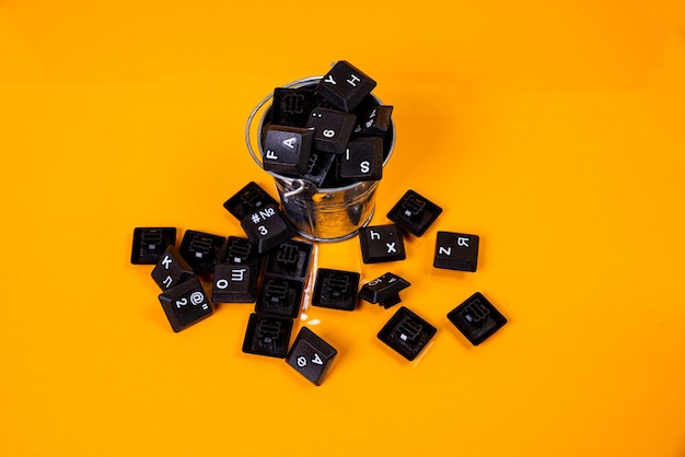 Keyboard button in glass in jar in bucket on orange background