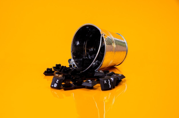 Photo keyboard button in glass in jar in bucket on orange background