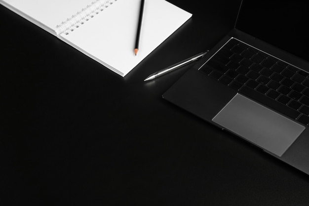 keyboard buttons and laptop fragments in black and silver background