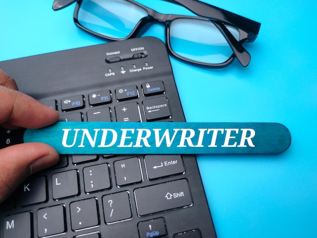 Keyboard and glasses with the word UNDERWRITER