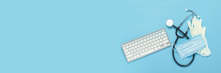 Photo keyboard, medical stethoscope, latex gloves and a protective mask on a blue background. concept medicine, hospital, safety, epidemic, doctor's call, online, consultation.