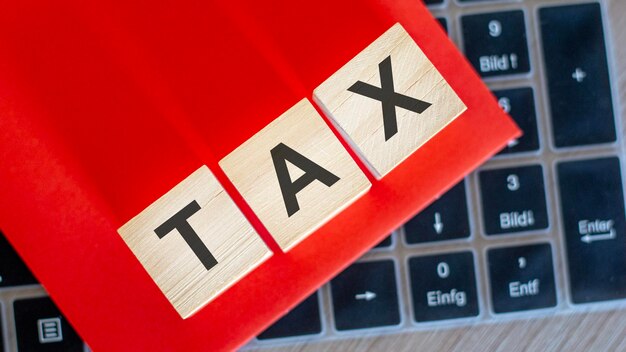 On keyboard notebook cubes with the inscription TAX red background