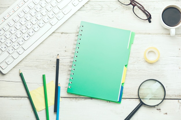 keyboard,notebook and stationary on table