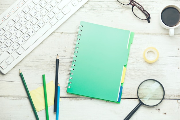 Keyboard,notebook and stationary on table