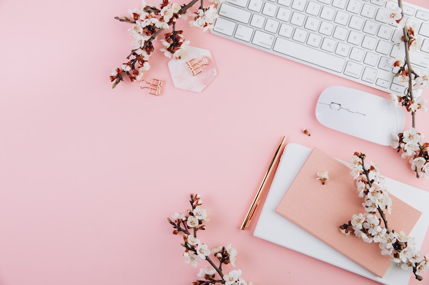 Photo keyboard and notebook with cherry blossom branches