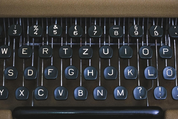Photo keyboard of an old retro typewriter with the english alphabet.