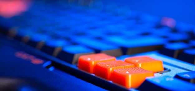 Keyboard professional video gamers with computer. cyber sport\
championship, neon blue color lights