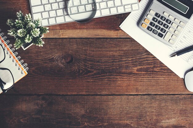 Keyboard with notepad and calculator on desk