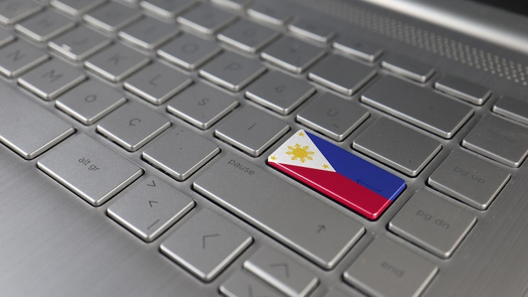 Photo keyboard with philippines flag on the enter button represents cyber attack learning language