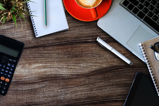 Keyboard with tablet are on top of office desk table with cup of latte coffee and calculator in office top view Online Shopping Concepts