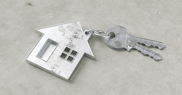 Keys with house shaped keychain on a concrete ground floor as a house purchase and housing concept