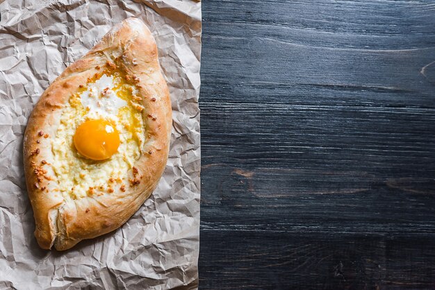 Khachapuri in Adzharian with Adyghe cheese, cheese and yolk. Traditional Caucasian food