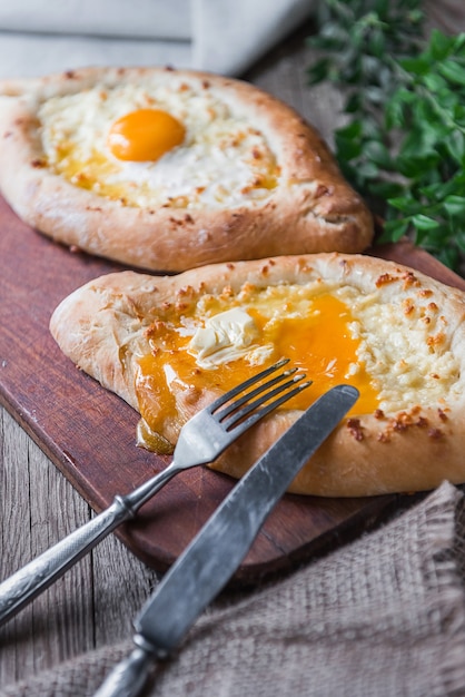 Khachapuri in Adzharian with Adyghe cheese, cheese and yolk. Traditional Caucasian food