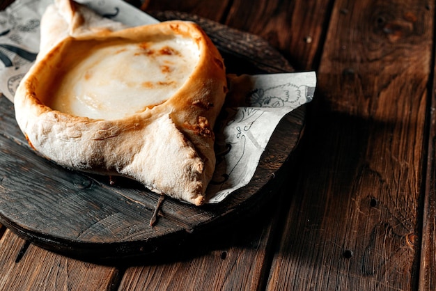 Khachapuri is a traditional Georgian bread with cheese filling egg yolk and butter Georgian bread High quality photo