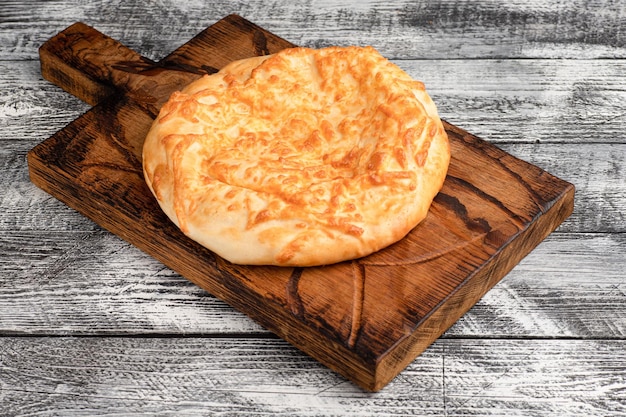 Khachapuri khachapuri in Megrelian on a wooden white background