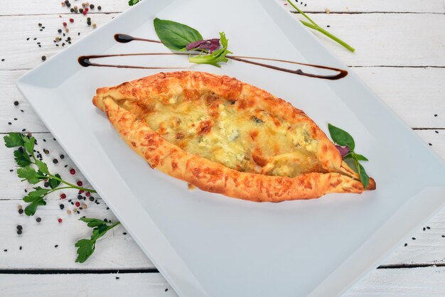 Khachapuri with cheese Georgian cuisine Top view On a wooden background Copy space