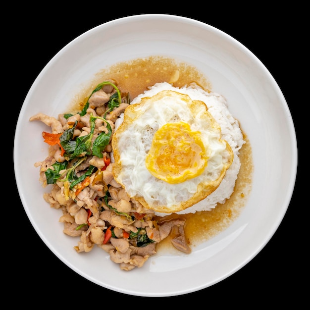 Khao Pad Ka Prao Gai Kai Dao Thai food streamed rice topped with basil stir fried chicken and fried egg in ceramic plate isolated on black background square ratio