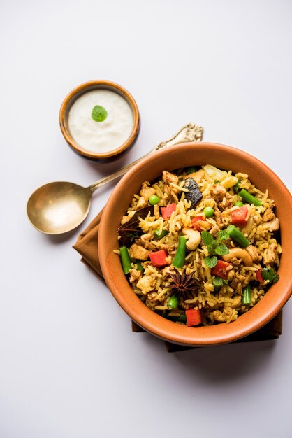 Kheema Pulao - Rice cooked with mutton or chicken mince with vegetables and spices. served in a bowl. selective focus