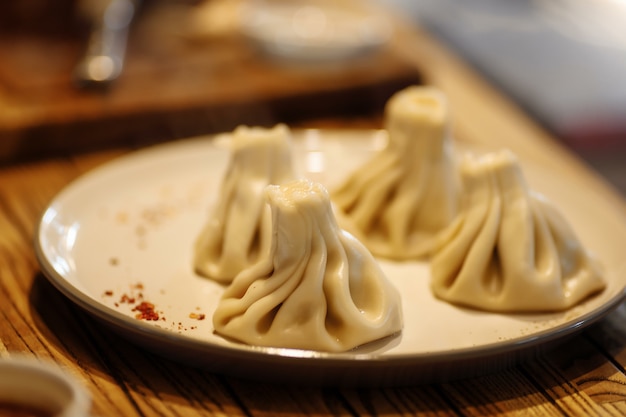 Khinkali cooked on a ceramic white plate