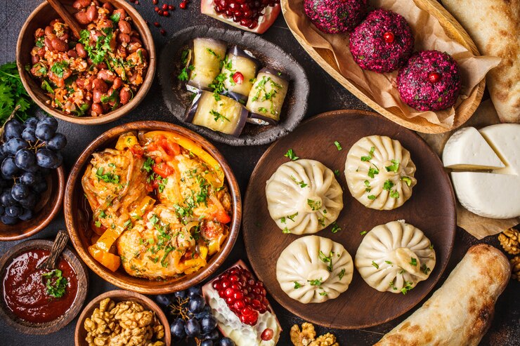  Khinkali, phali, chakhokhbili, lobio, cheese, eggplant rolls, dark table.