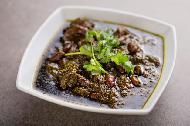 Khoresh sabzi served in dish isolated on grey background top view of arabic food