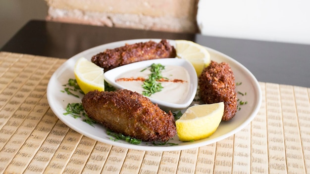 Kibbeh with tahini sauce. Kibbeh is like a croquette in its most common form consists of minced lamb