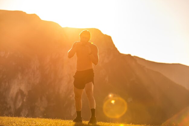 A kickboxer training on top of a mountain and preparing for a fight.