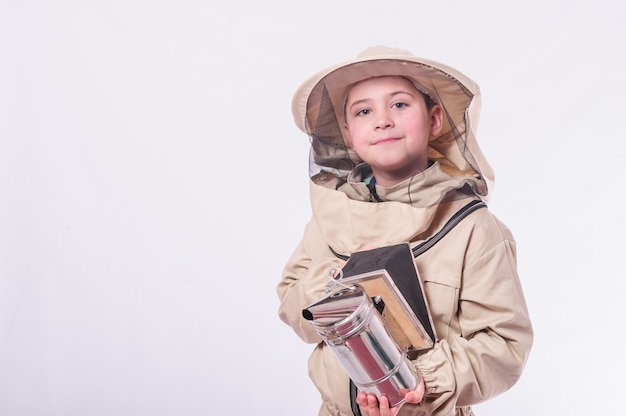 Kid in beekeeper's suits posing in studio white background.