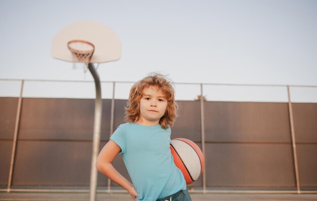 Kid boy child concentrated on playing basketball