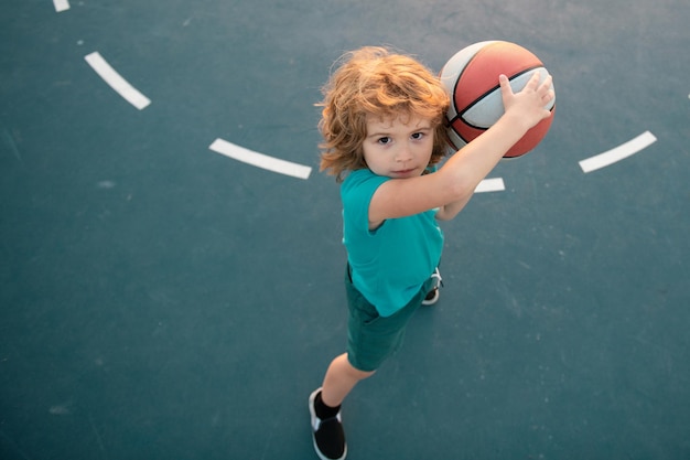 Kid boy concentrated on playing basketball basketball kids school