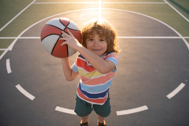 kid boy concentrated on playing basketball sport for kids