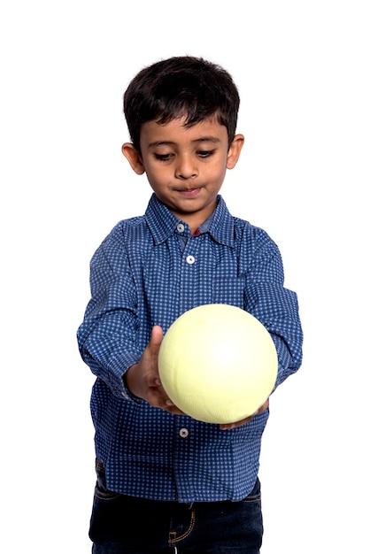 Kid boy playing with ball on white background