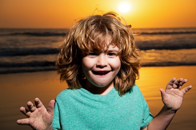 Kid boy portrait on sunset beach thumbs up amazed surprised kids emotions with fynny face