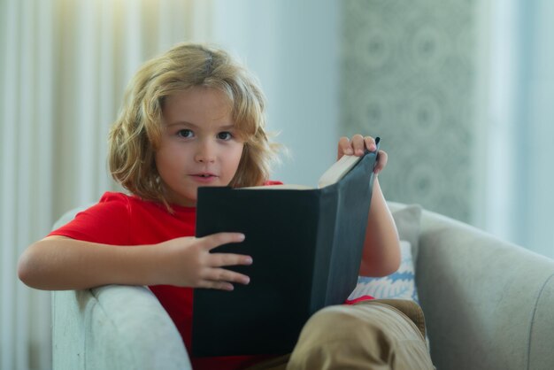 Kid boy reading book at living room concept of education childhood book reading and inspiration