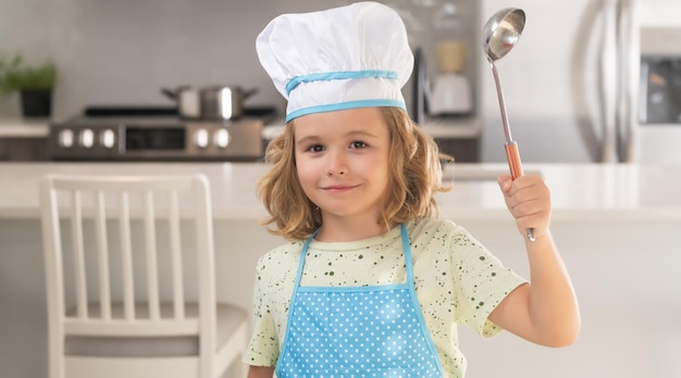 Kid chef cook in chef hat preparing food on kitchen Child making tasty delicious Cooking meal