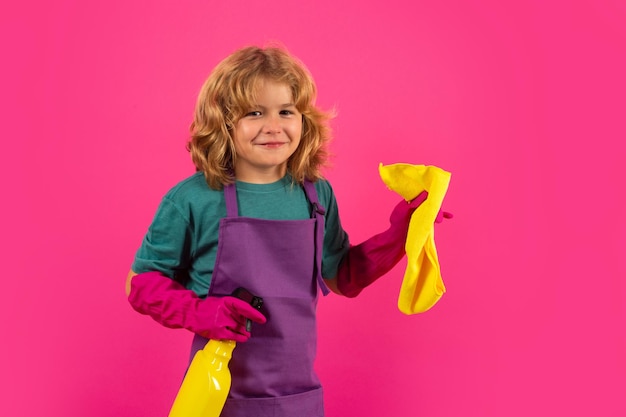 Kid cleans at home Child cleaning with mop to help with housework Little cute boy sweeping and cleaning isolated on studio pink color background