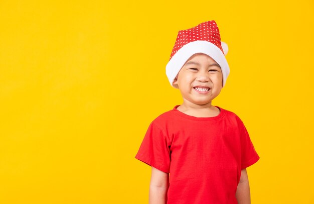 Kid dressed in red Santa Claus hat Portrait of Asian little cute boy smile and excited