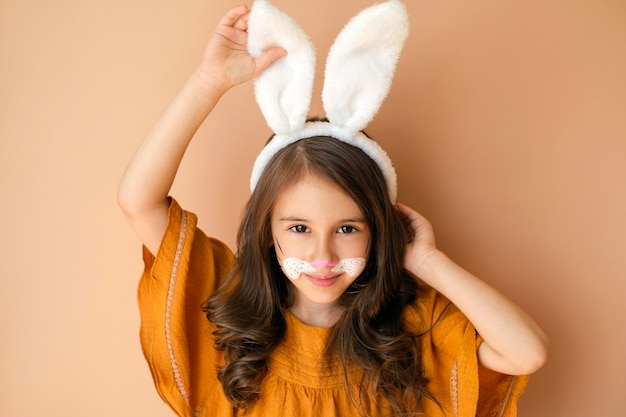 Kid dressed up as a rabbit with a painted face