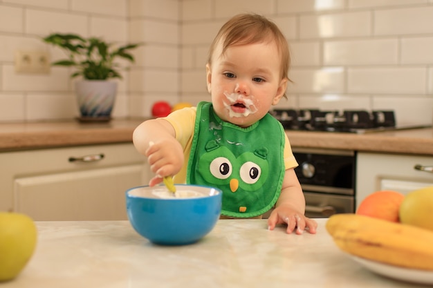 kid eats at the table in the kitchen