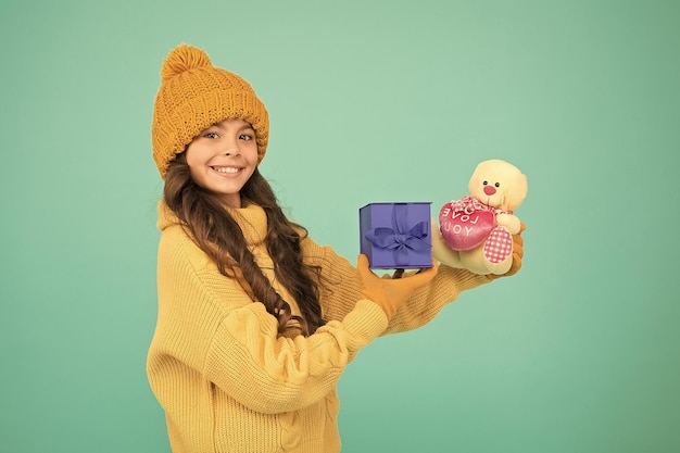 Kid girl delighted christmas gift unexpected surprise winter\
holidays celebrate birthday kid love birthday gift feeling grateful\
for good gift surprise present box child happy hold gift box