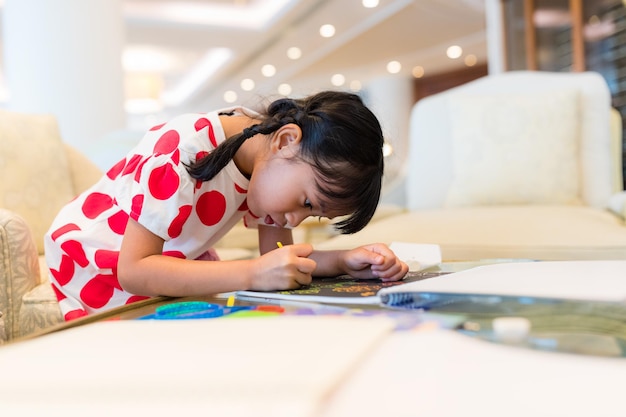 Kid girl draw on book