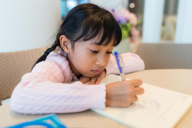 Kid girl draw on book