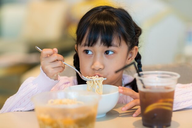 Kid girl eat instant noodles