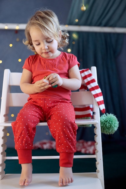 Kid girl red pajamas decorating room christmas winter holidays new year eve